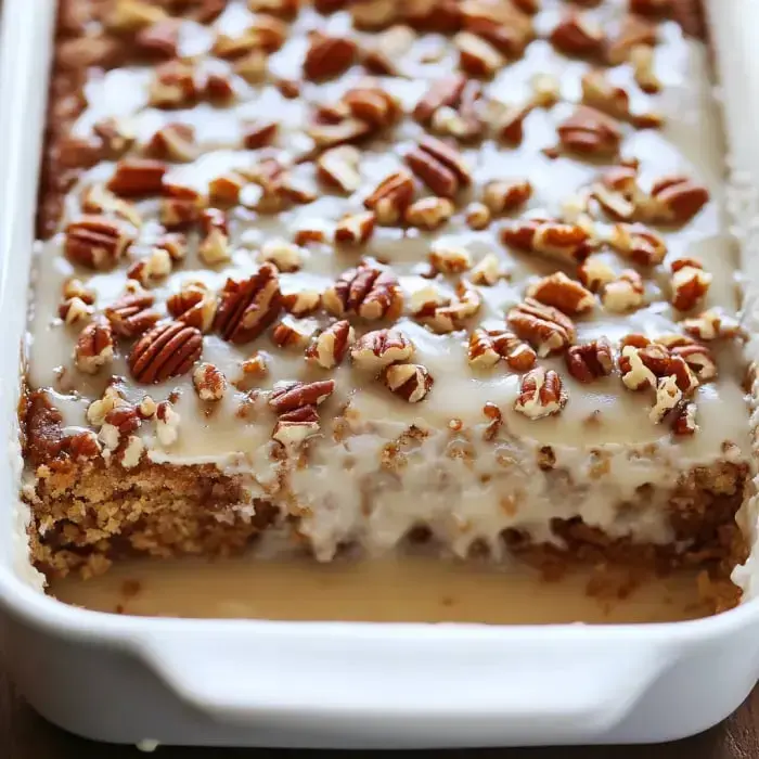 A creamy treat packed with pecans shown up close in a baking pan.