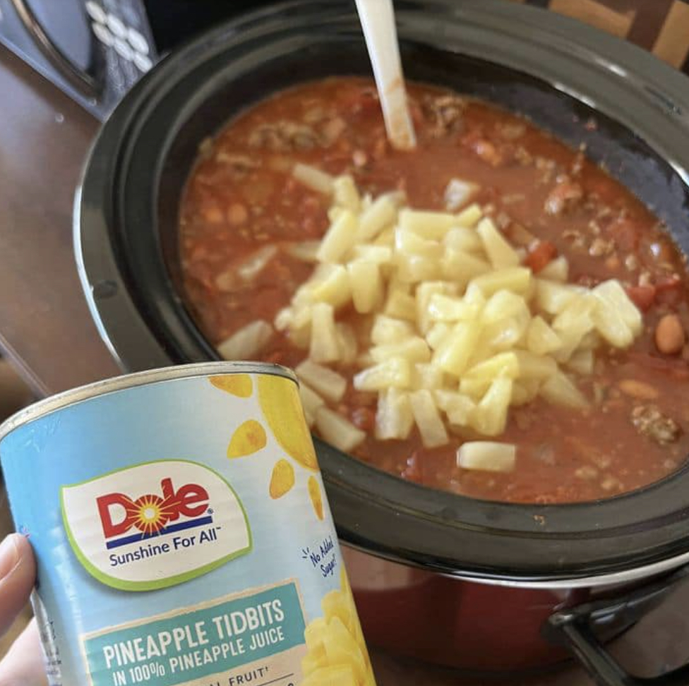 Chili simmering next to pineapple juice can.