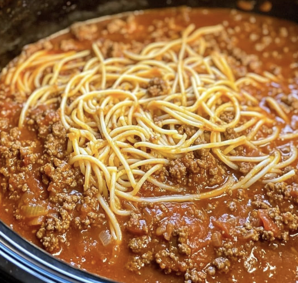 A comforting bowl of spaghetti topped with meat sauce.