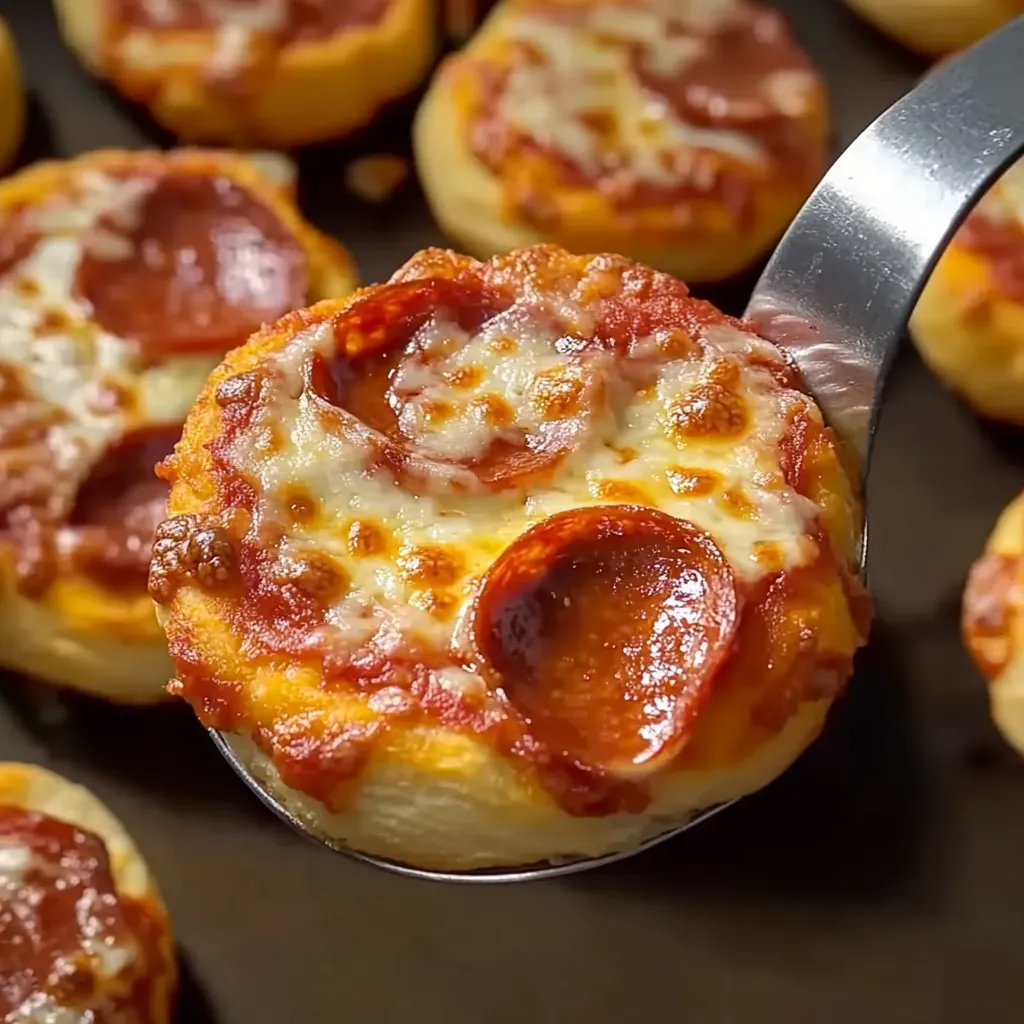 A spoon is holding a slice of pizza.