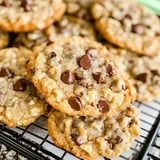 Freshly baked chocolate chip cookies with golden crisp edges and a rich texture, cooling on a rack.