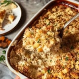 Spoon lifts creamy casserole with golden breadcrumb topping, surrounded by dish and bread-filled plates.