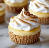 Close-up of a small lemon dessert with toasted meringue top and crumbly graham base.