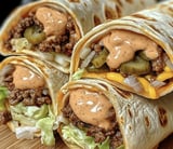 A tortilla filled and topped with sauce.